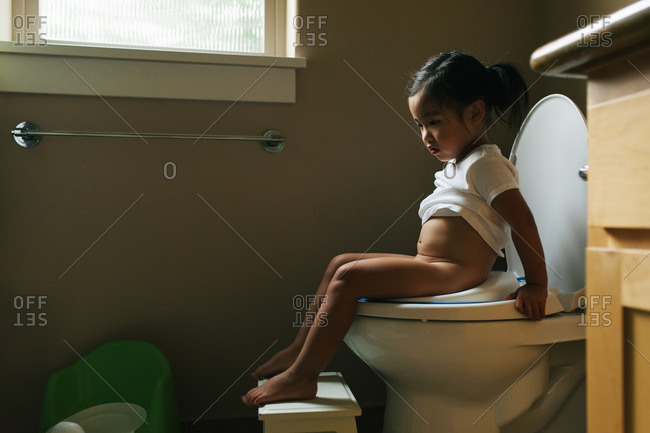 girl sit on toilet