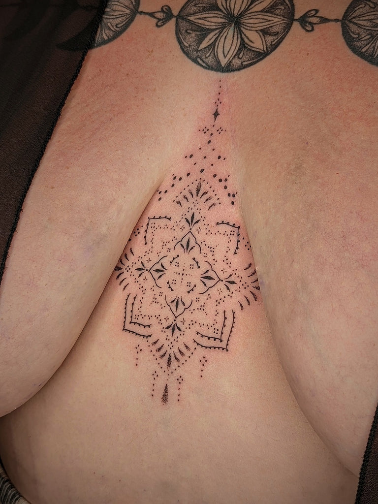 between the boobs tattoo
