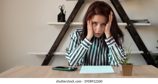 bent over the desk