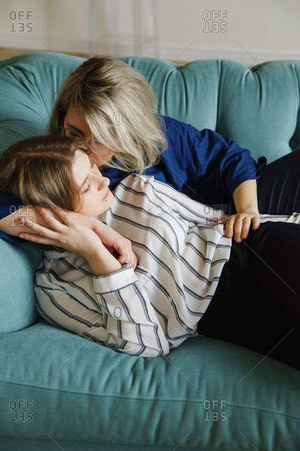 lesbians kissing on couch